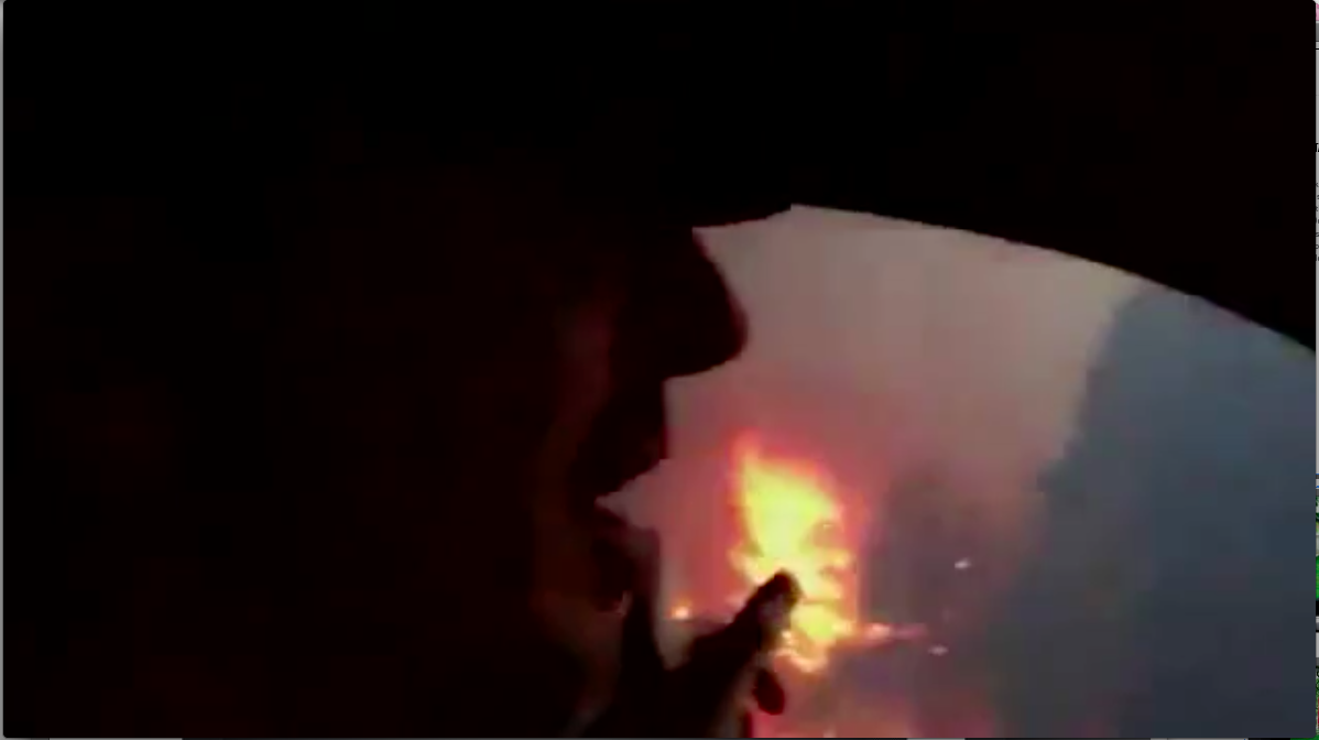 Douglas County Sheriff’s Department early warning campaign: a silhouetted passenger in a dark vehicle watching wildfire flames through the window